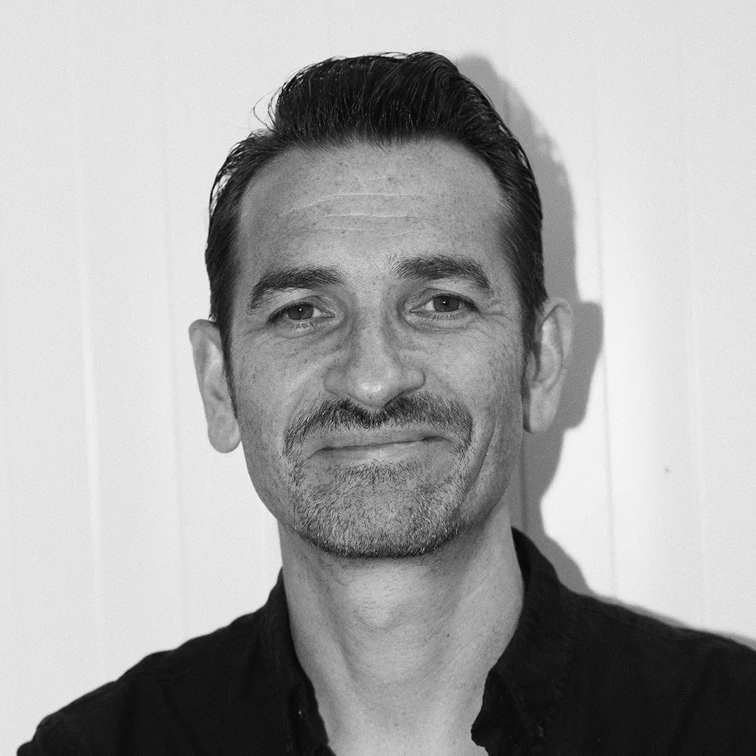 A black and white portrait of Patrick Olsson, the managing director of Belle Maison.