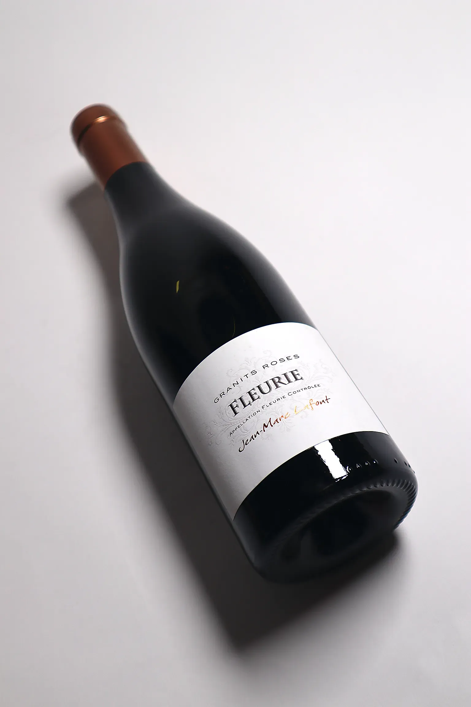 An image with a wine bottle in an artistic light.